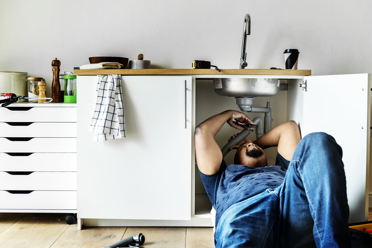 plumber-man-fixing-kitchen-sink-1200